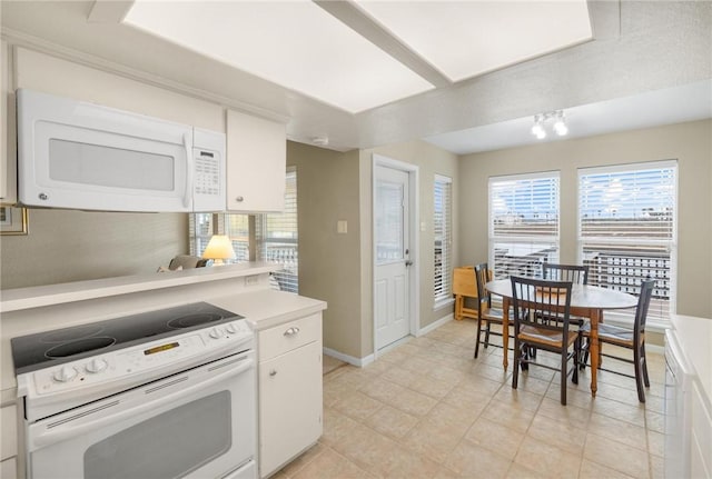 kitchen with white appliances and white cabinets