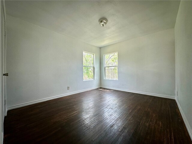 unfurnished room featuring dark hardwood / wood-style flooring