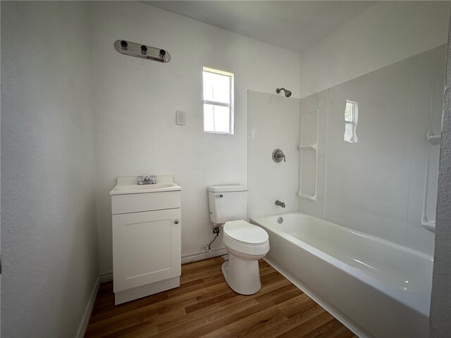 full bathroom with vanity, wood-type flooring, tub / shower combination, and toilet