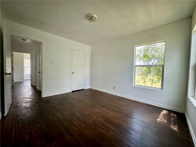 unfurnished bedroom featuring dark hardwood / wood-style flooring