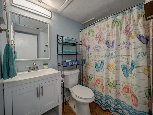 3938 Surfside Blvd Unit 3124, Corpus Christi, TX 78402 - full bath featuring toilet, vanity, a textured ceiling, tile patterned flooring, and curtained shower