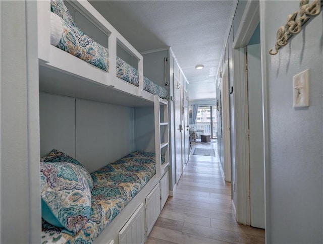 3938 Surfside Blvd Unit 3124, Corpus Christi, TX 78402 - bedroom with a textured ceiling, light wood-type flooring, and french doors