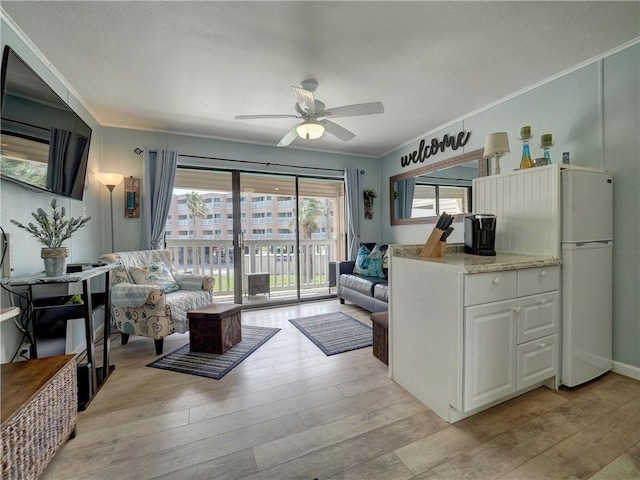 3938 Surfside Blvd Unit 3124, Corpus Christi, TX 78402 - living room featuring ceiling fan, light wood finished floors, and ornamental molding