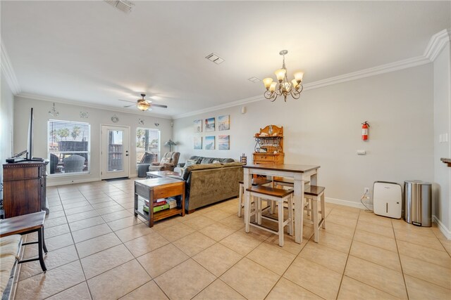 interior space featuring a kitchen bar, light tile patterned floors, ornamental molding, and ceiling fan with notable chandelier