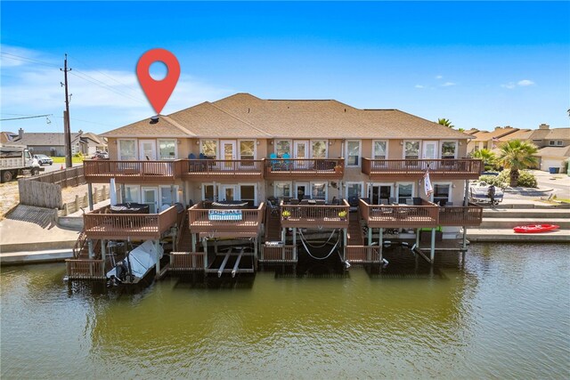 exterior space featuring a water view and a balcony