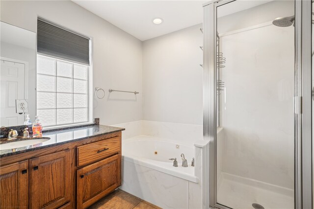 bathroom featuring vanity, tile patterned floors, and plus walk in shower