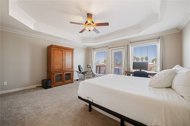 carpeted bedroom with ceiling fan, a raised ceiling, access to exterior, and ornamental molding