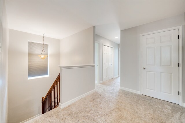 corridor with light colored carpet