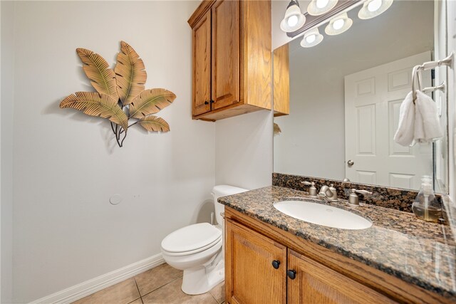 bathroom with vanity, tile patterned floors, and toilet