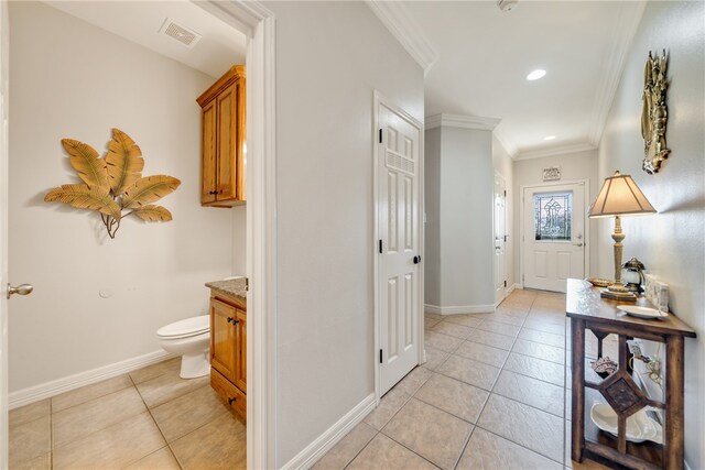 interior space with light tile patterned floors and crown molding