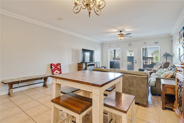 tiled dining area with ornamental molding and ceiling fan with notable chandelier