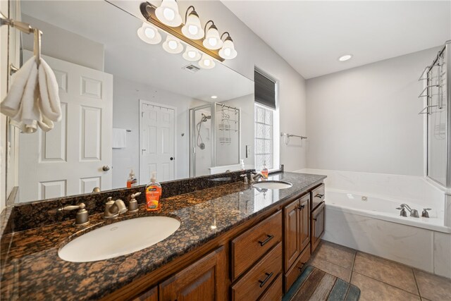 bathroom with tile patterned flooring, vanity, and plus walk in shower