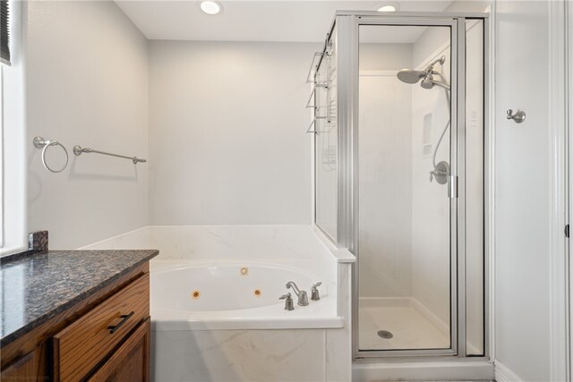 bathroom featuring vanity and separate shower and tub