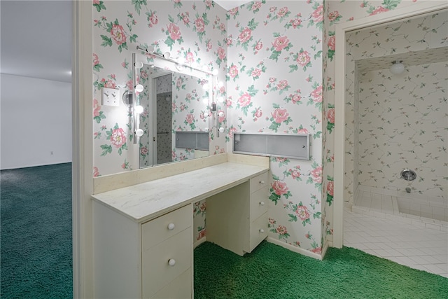 bathroom with vanity and tiled shower