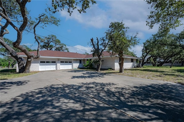 1405 Omohundro St, Rockport, TX 78382 - ranch-style house featuring a garage, driveway, and a front lawn