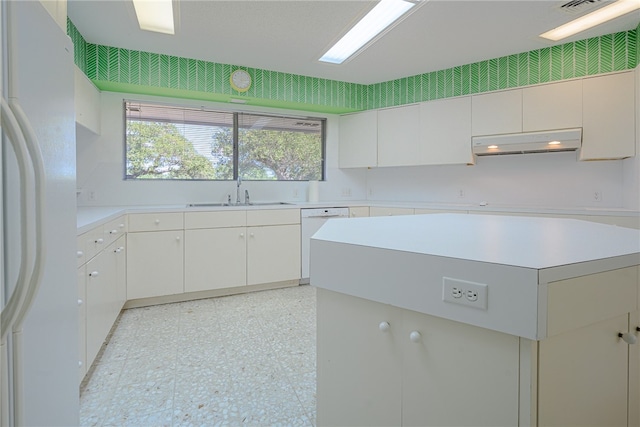 kitchen featuring white appliances, white cabinetry, and sink