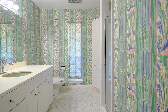 1405 Omohundro St, Rockport, TX 78382 - full bath featuring wallpapered walls, a shower stall, toilet, vanity, and tile patterned floors