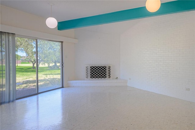 1405 Omohundro St, Rockport, TX 78382 - unfurnished living room featuring brick wall