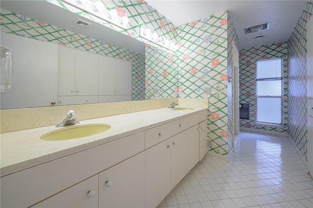 1405 Omohundro St, Rockport, TX 78382 - full bathroom with wallpapered walls, tile patterned flooring, and double vanity