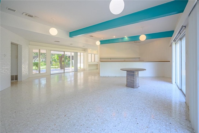 1405 Omohundro St, Rockport, TX 78382 - unfurnished living room with healthy amount of natural light and beamed ceiling
