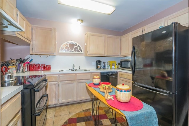 13656 Teague Ln Unit 22, Corpus Christi, TX 78410 - kitchen with black appliances, under cabinet range hood, light brown cabinets, light countertops, and light tile patterned floors