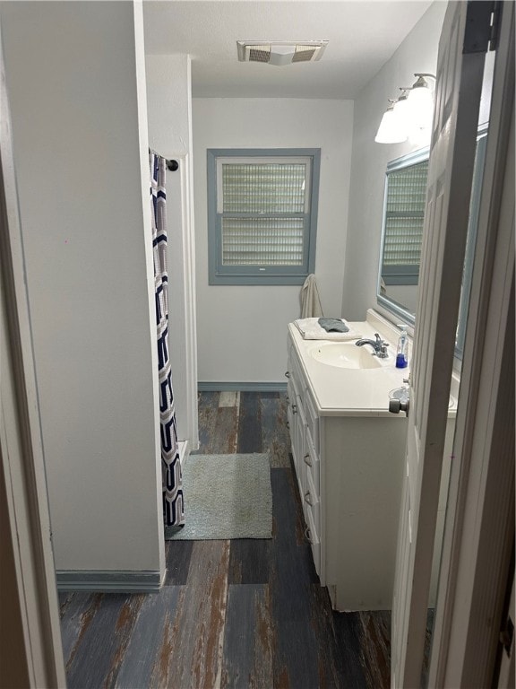 bathroom with hardwood / wood-style floors and vanity