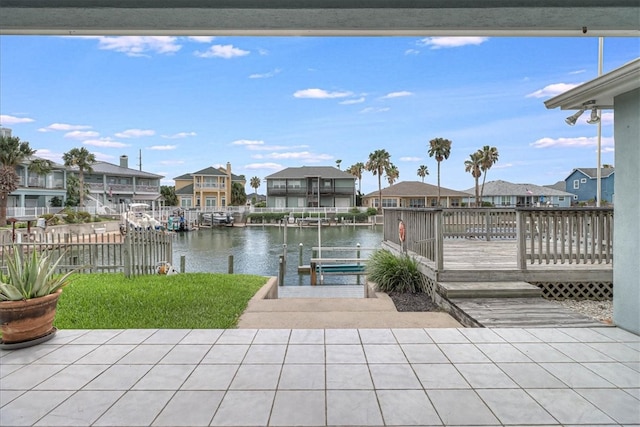 view of patio featuring a boat dock and a deck with water view