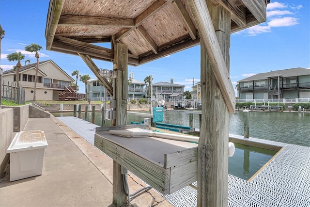 exterior space featuring a boat dock and a water view