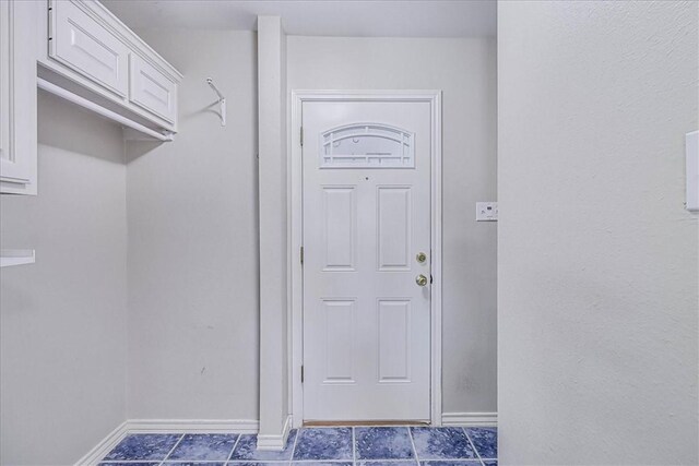 123 Sea Mist Dr, Aransas Pass, TX 78336 - entryway with baseboards and dark tile patterned floors