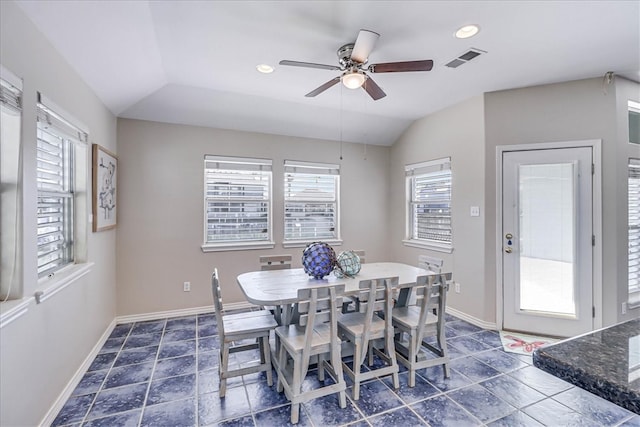 dining room with ceiling fan, a wealth of natural light, and vaulted ceiling