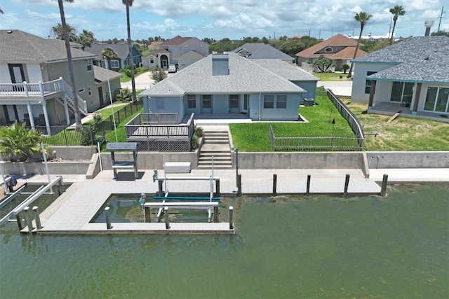 view of dock with a yard and a water view