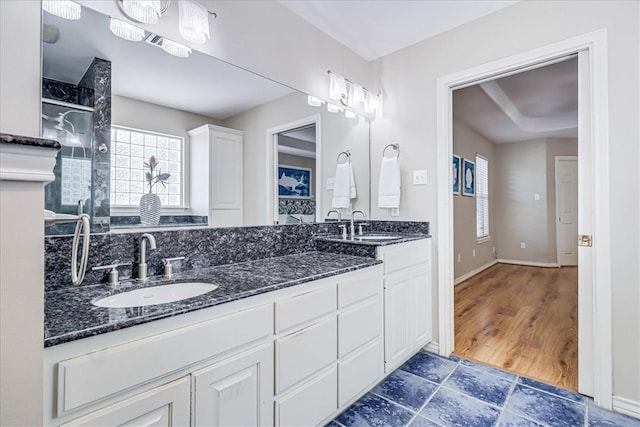 bathroom with a shower, vanity, and hardwood / wood-style flooring