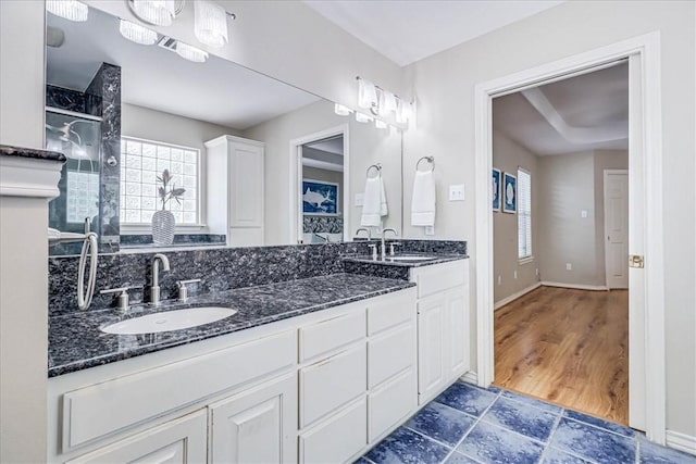 123 Sea Mist Dr, Aransas Pass, TX 78336 - full bathroom featuring a shower stall, plenty of natural light, double vanity, and baseboards
