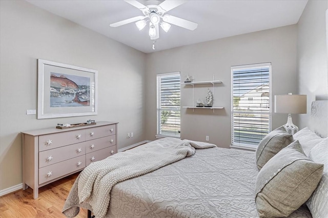 123 Sea Mist Dr, Aransas Pass, TX 78336 - bedroom featuring light wood-style flooring, a ceiling fan, and baseboards
