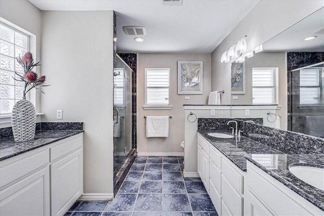 123 Sea Mist Dr, Aransas Pass, TX 78336 - bathroom with a shower stall, double vanity, baseboards, and toilet