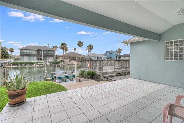 view of patio / terrace featuring a deck with water view and a dock