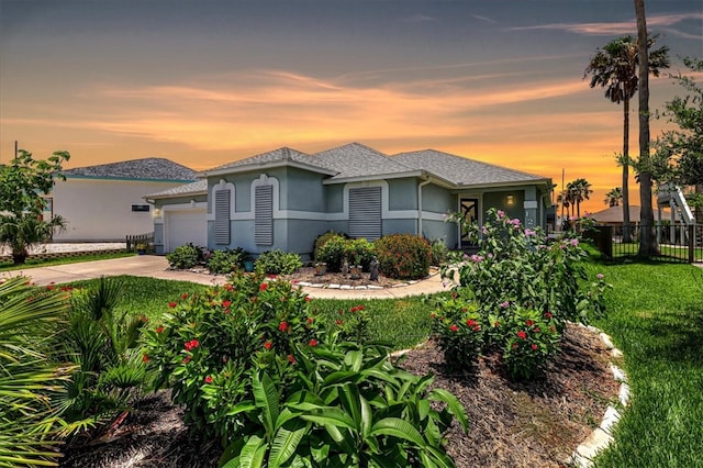 view of front facade featuring a lawn and a garage