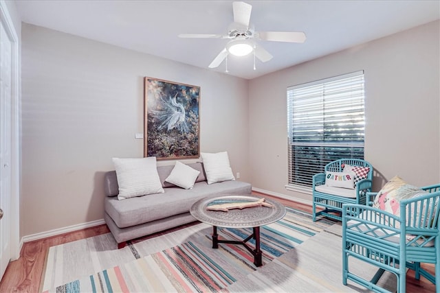 living room featuring ceiling fan and light hardwood / wood-style flooring