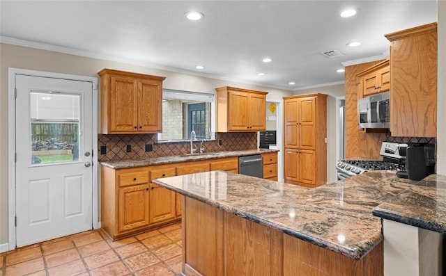 kitchen with decorative backsplash, sink, ornamental molding, appliances with stainless steel finishes, and dark stone countertops