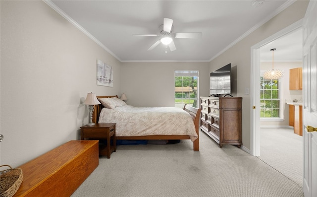 carpeted bedroom with ceiling fan and crown molding