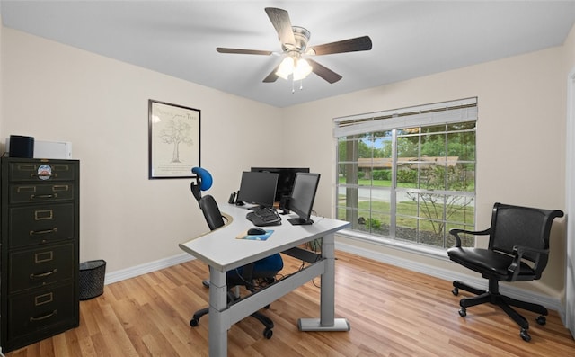 home office featuring ceiling fan and light hardwood / wood-style floors