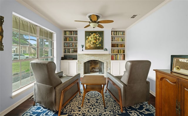 sitting room featuring built in features, hardwood / wood-style floors, and plenty of natural light