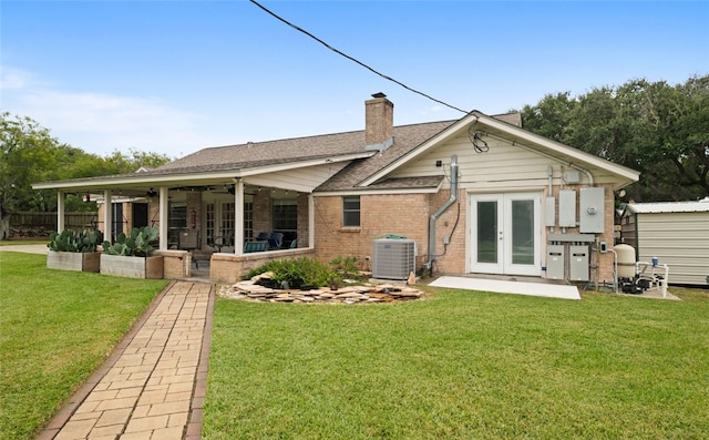 back of property featuring cooling unit, french doors, a patio, a yard, and ceiling fan