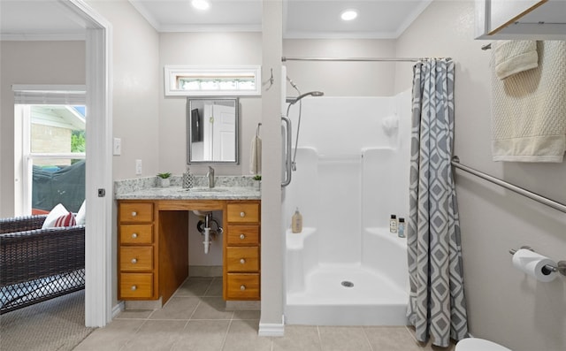 bathroom with vanity, walk in shower, tile patterned flooring, and ornamental molding