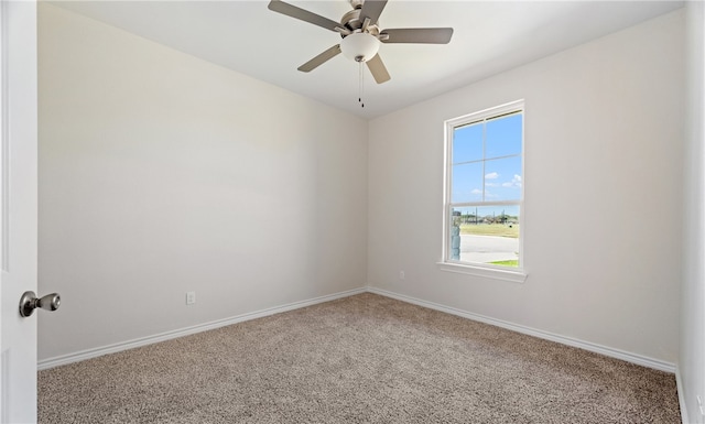 spare room featuring baseboards, carpet floors, and a ceiling fan