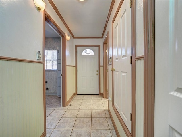 4821 Kosarek Dr, Corpus Christi, TX 78415 - entryway featuring light tile patterned floors, wainscoting, and crown molding