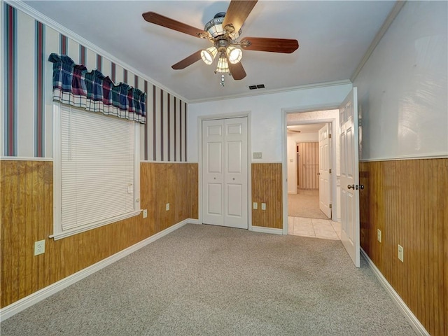 4821 Kosarek Dr, Corpus Christi, TX 78415 - unfurnished bedroom with wainscoting, carpet floors, ornamental molding, wooden walls, and a closet