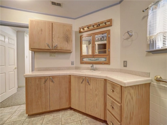 4821 Kosarek Dr, Corpus Christi, TX 78415 - kitchen featuring crown molding, light brown cabinets, light tile patterned floors, and light countertops
