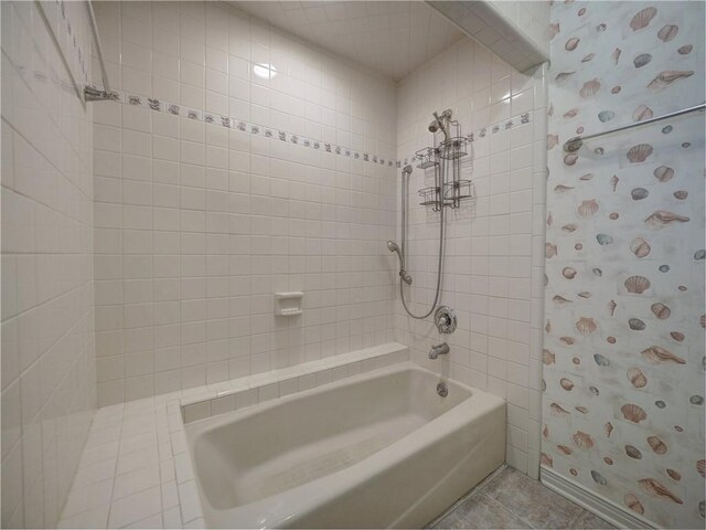 4821 Kosarek Dr, Corpus Christi, TX 78415 - bathroom featuring bathtub / shower combination and tile patterned flooring