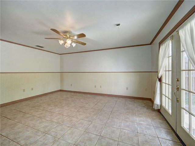 4821 Kosarek Dr, Corpus Christi, TX 78415 - spare room with french doors, ceiling fan, light tile patterned floors, ornamental molding, and wainscoting